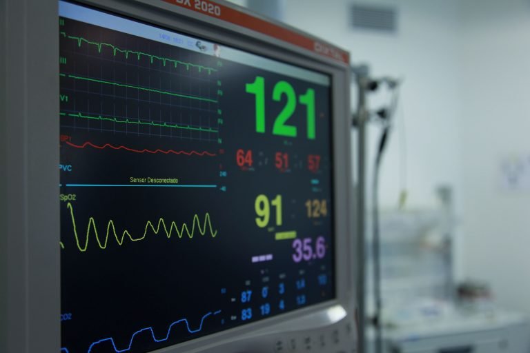 Cardiac monitor displaying ECG and vital signs in a Malaysian hospital